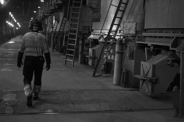 man walking black and white photography power station worker